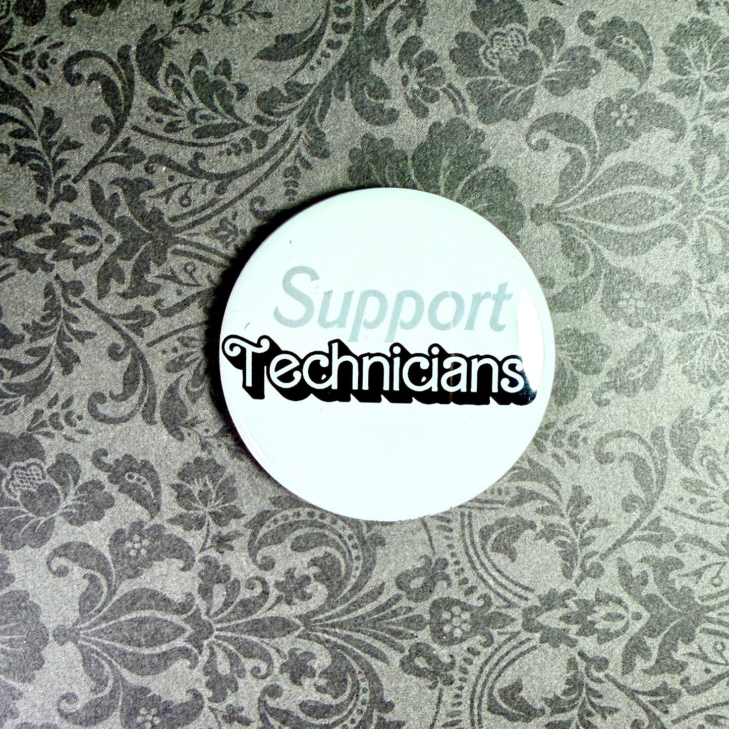 Round white button with 'Support Technicians' text on a floral patterned background