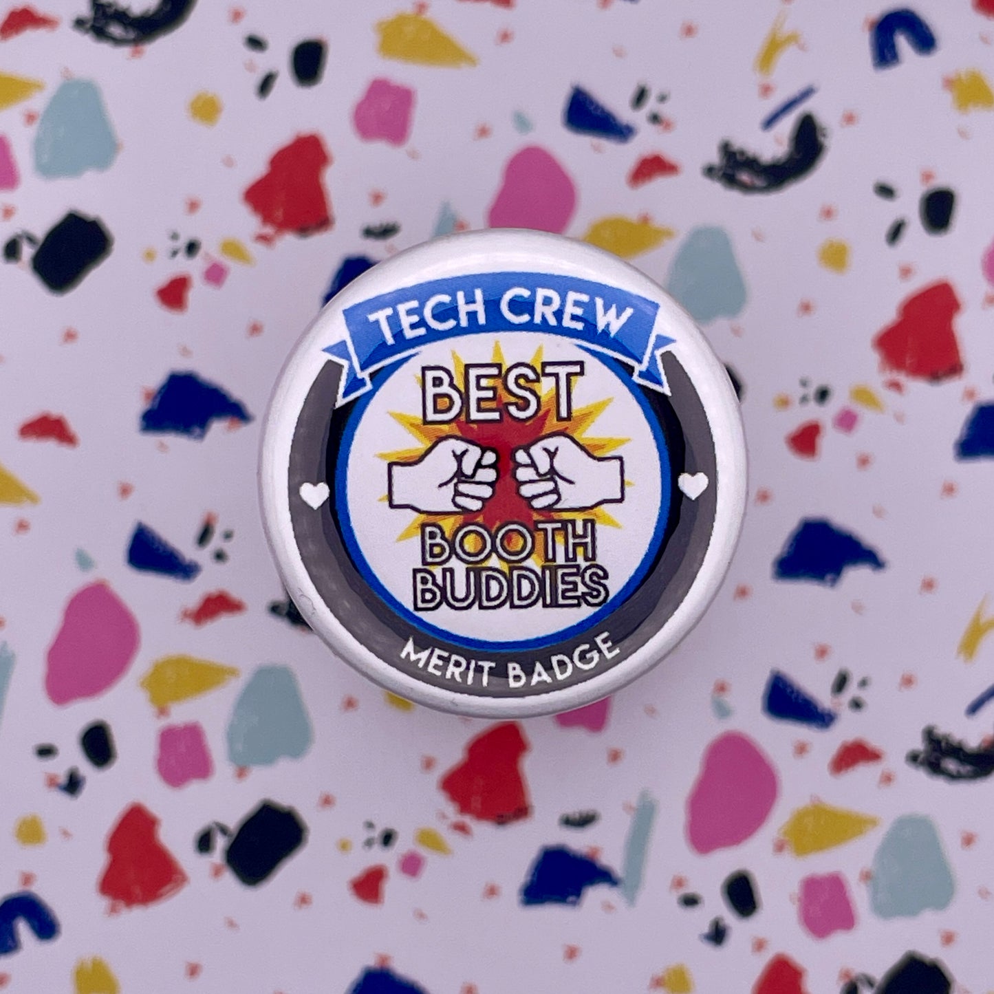 hands with best booth buddies font on a colorful background