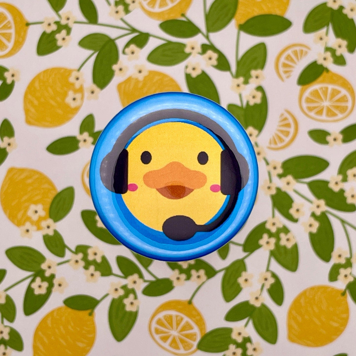 duck with stage manager headset on blue graphic on lemon background