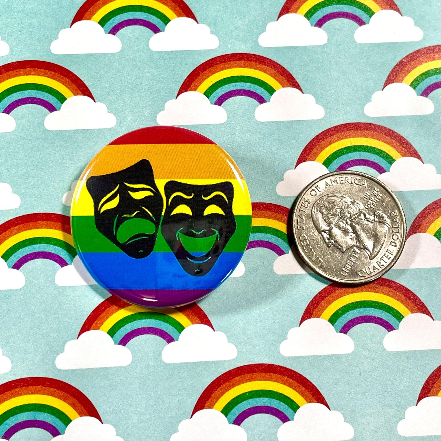 rainbow button with theatre masks and coin for size reference