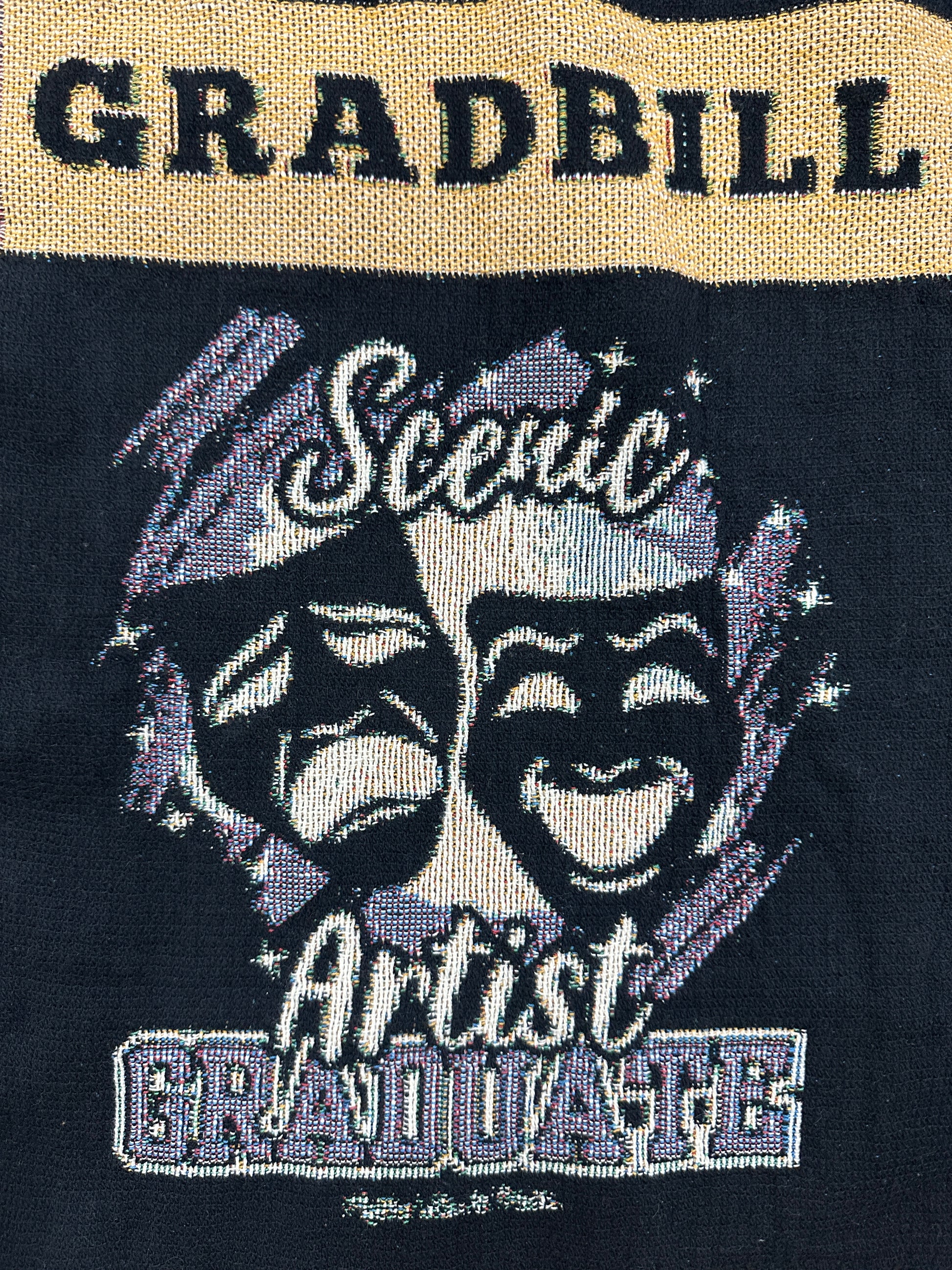 woven blanket with 'Gradbill' text and theatre design on a black background