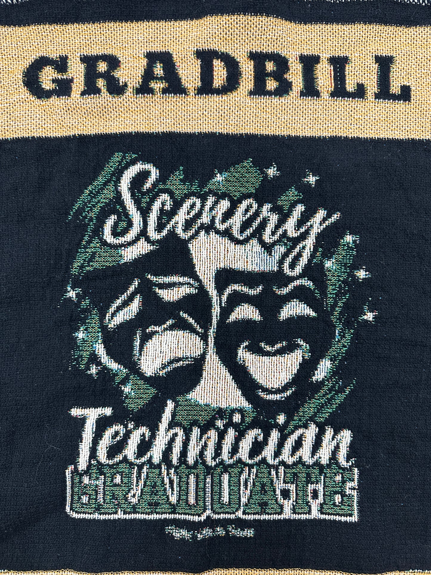 woven blanket with 'Gradbill' text and theatre design on a black background