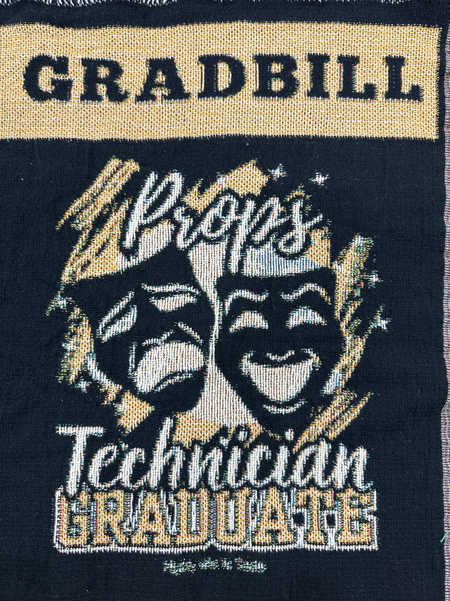 woven blanket with 'Gradbill' text and theatre design on a black background