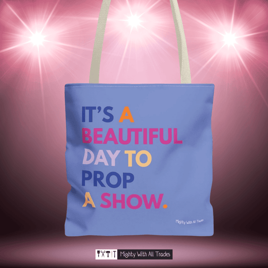 Purple tote bag with it's a beautiful day to prop a show colorful text on a pink background