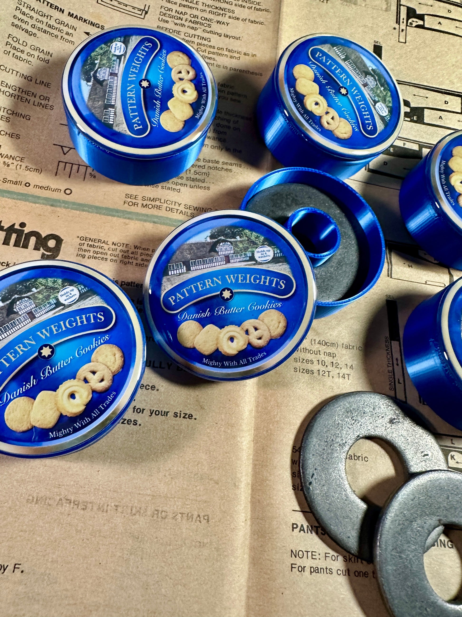 Pattern Weights Dutch Butter Cookie tins on a newspaper background