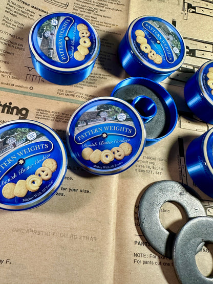 Pattern Weights Dutch Butter Cookie tins on a newspaper background