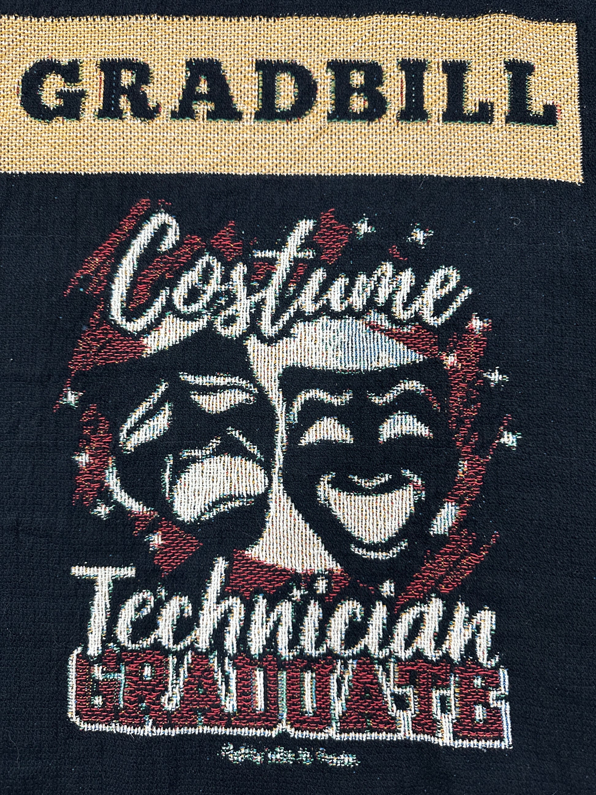 woven blanket with 'Gradbill' text and theatre design on a black background