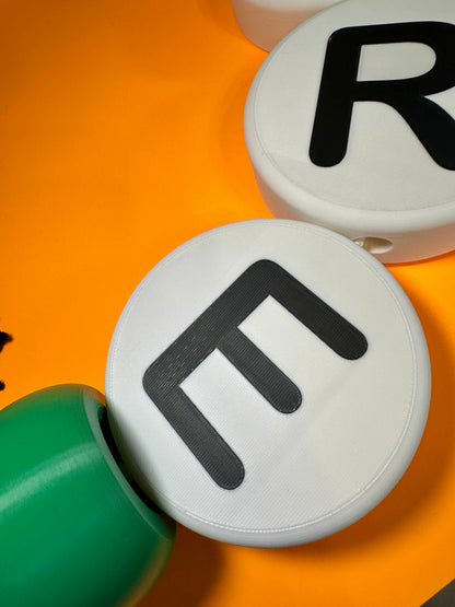 Two round white beads with black letters 'R' and 'E' on an orange background