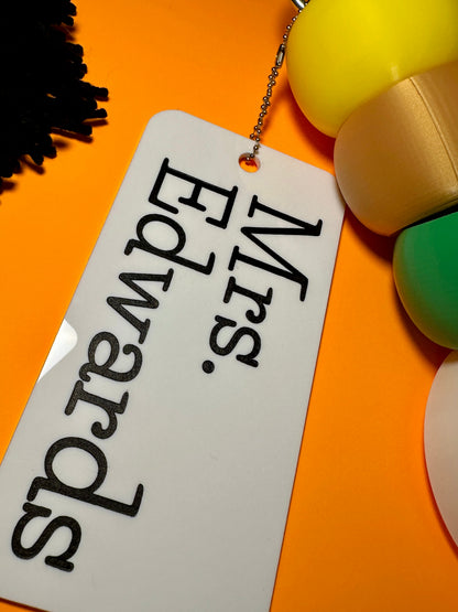 Personalized keychain tag with 'Mrs. Edwards' on a colorful background