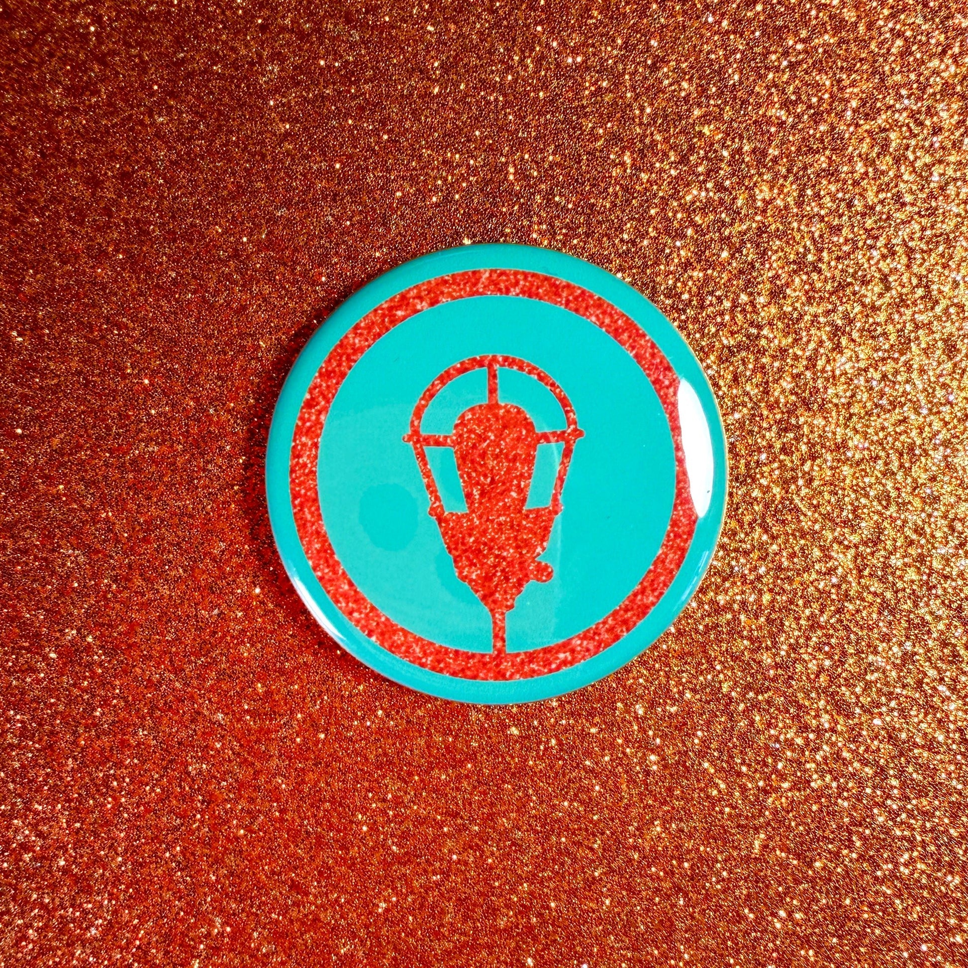 Circular badge with a design on a glittery brown background