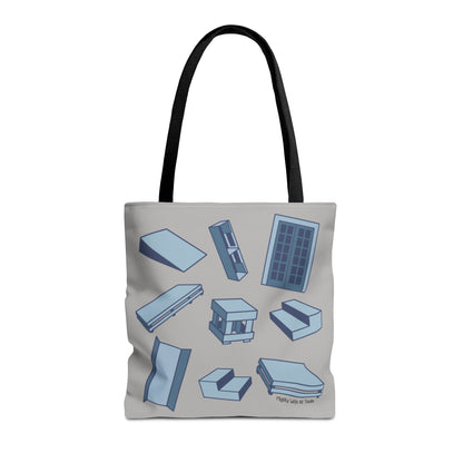 Tote bag with oil one act play set pieces designs on a wooden floor and blue curtain background Front