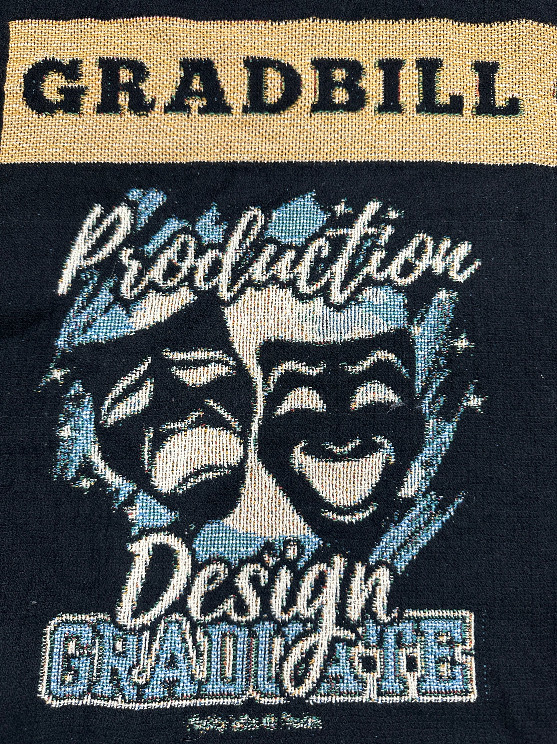 woven blanket with 'Gradbill' text and theatre design on a black background