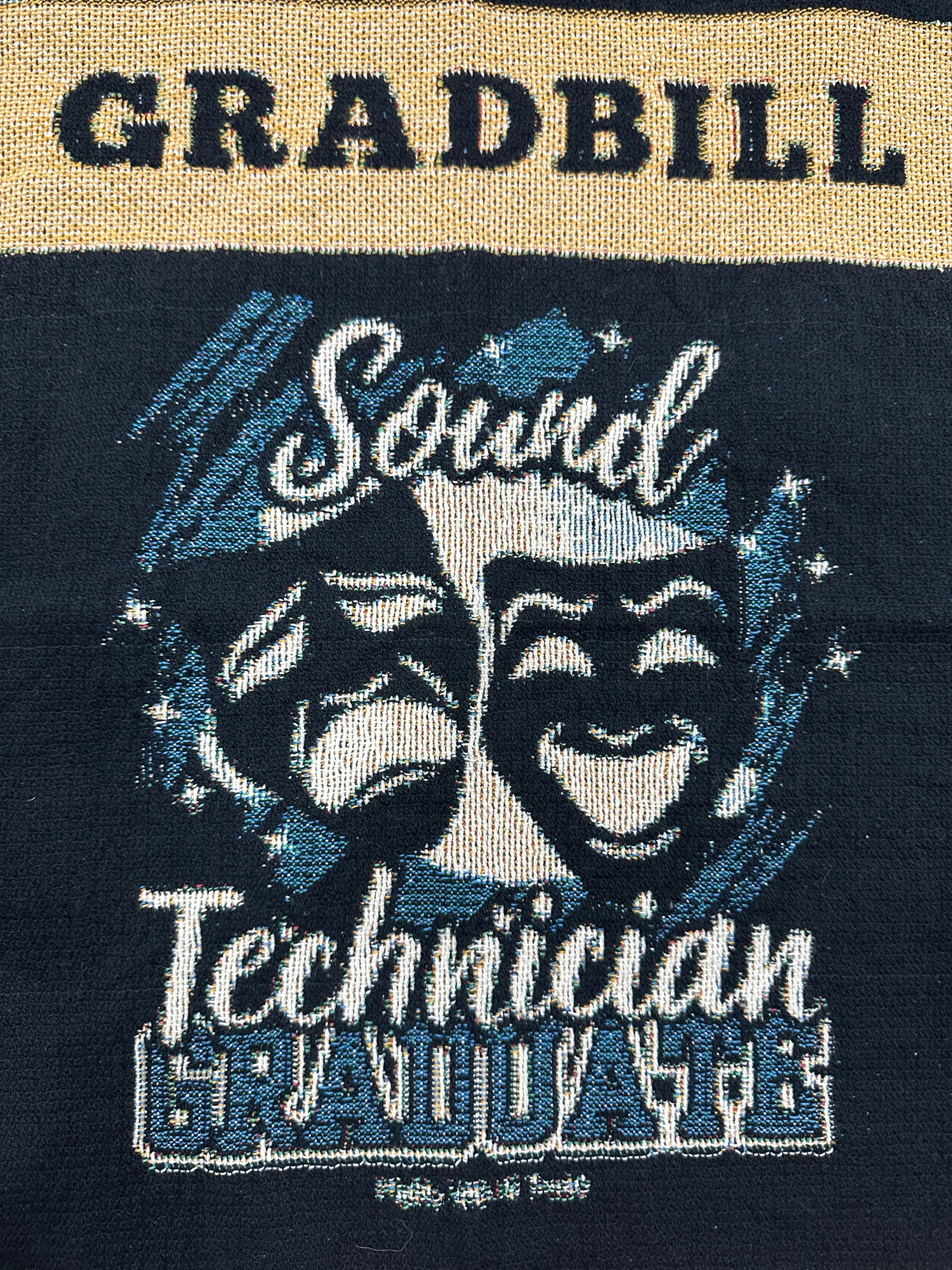 woven blanket with 'Gradbill' text and theatre design on a black background