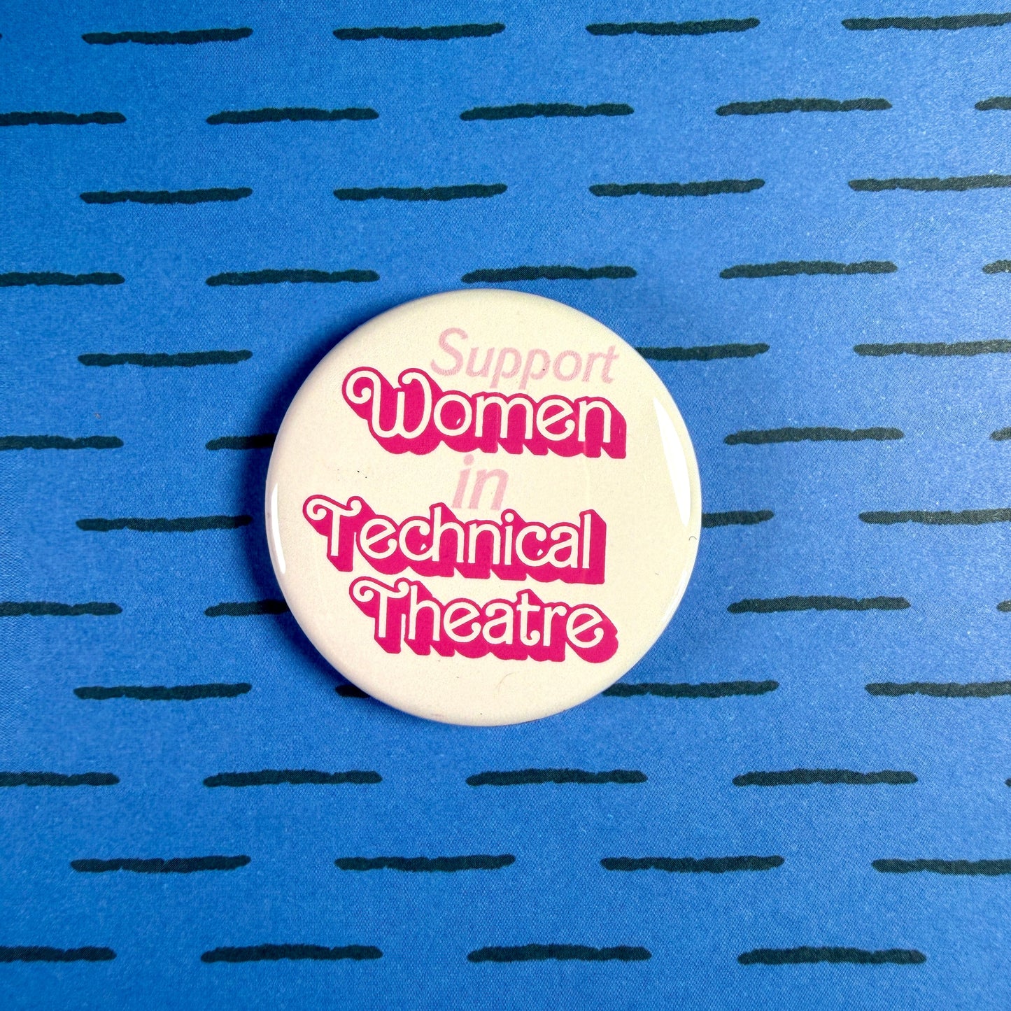 Button badge with 'Support Women in Technical Theatre' text on a blue background with black lines.
