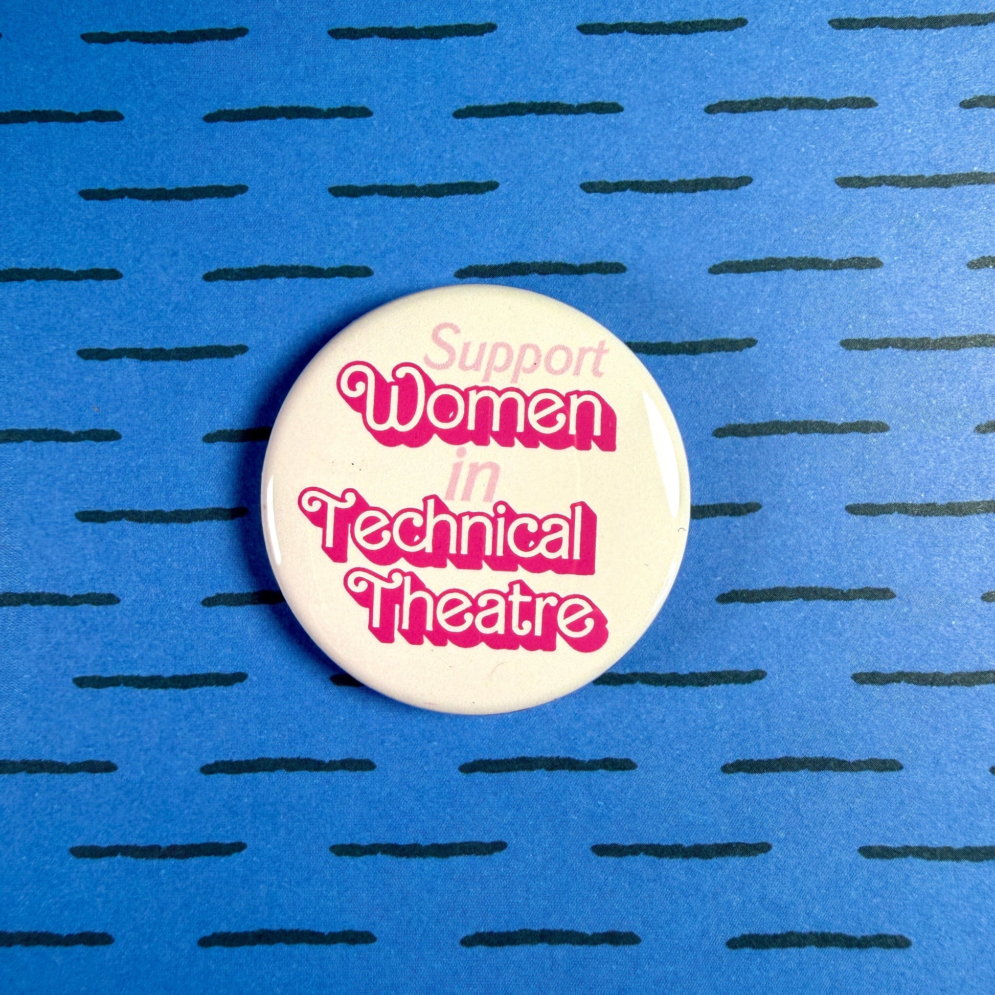 Button badge with 'Support Women in Technical Theatre' text on a blue background with black lines.