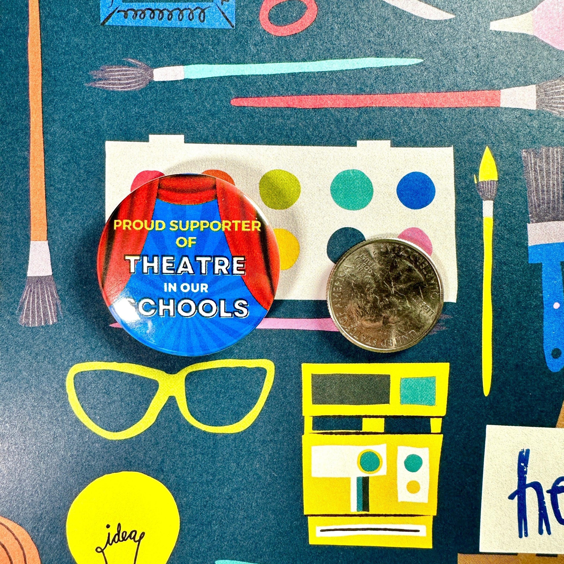 Button badge with 'Proud Supporter of Theatre in Our Schools' text on a colorful background with school supplies.