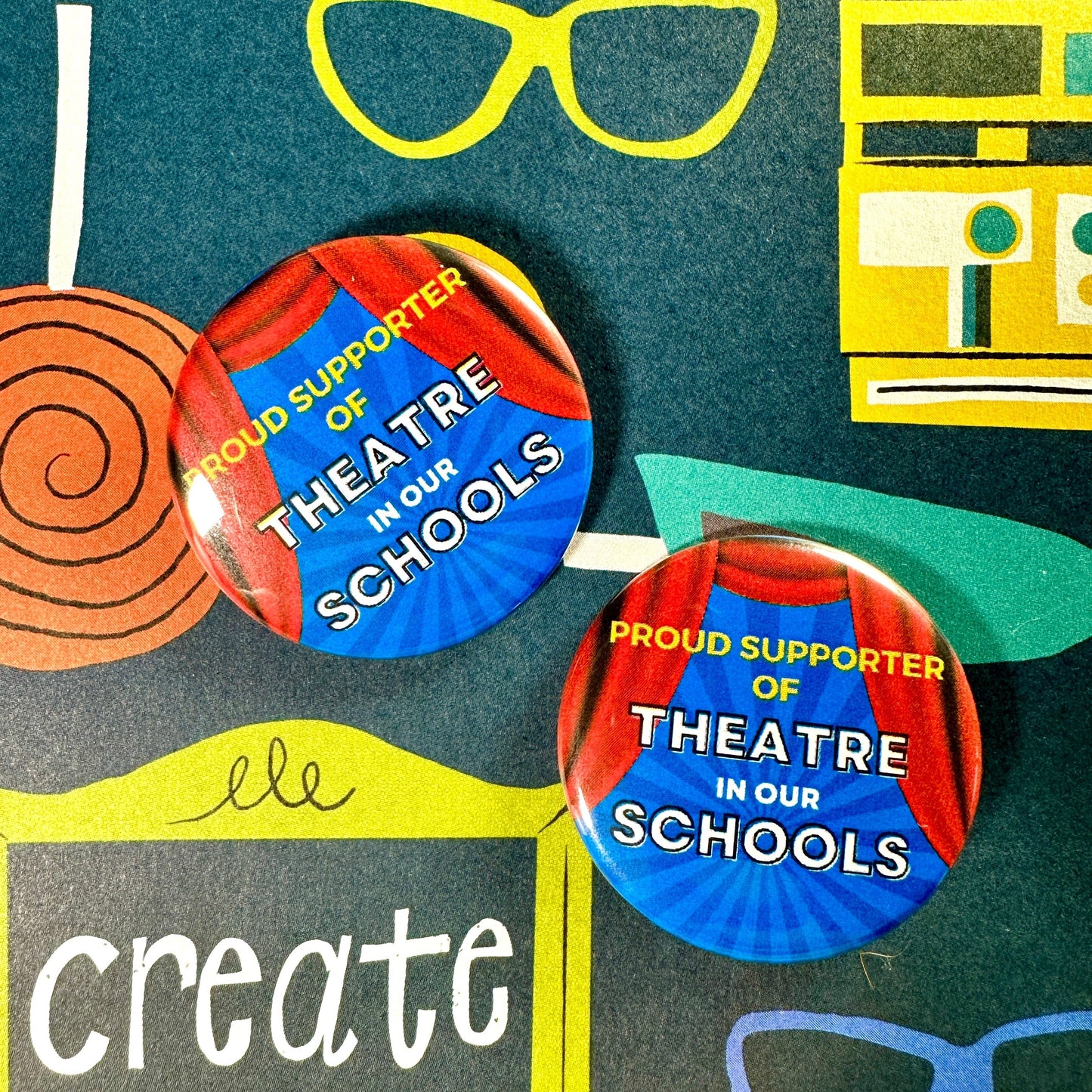 Two buttons with 'Proud Supporter of Theatre in Our Schools' text on a colorful background.