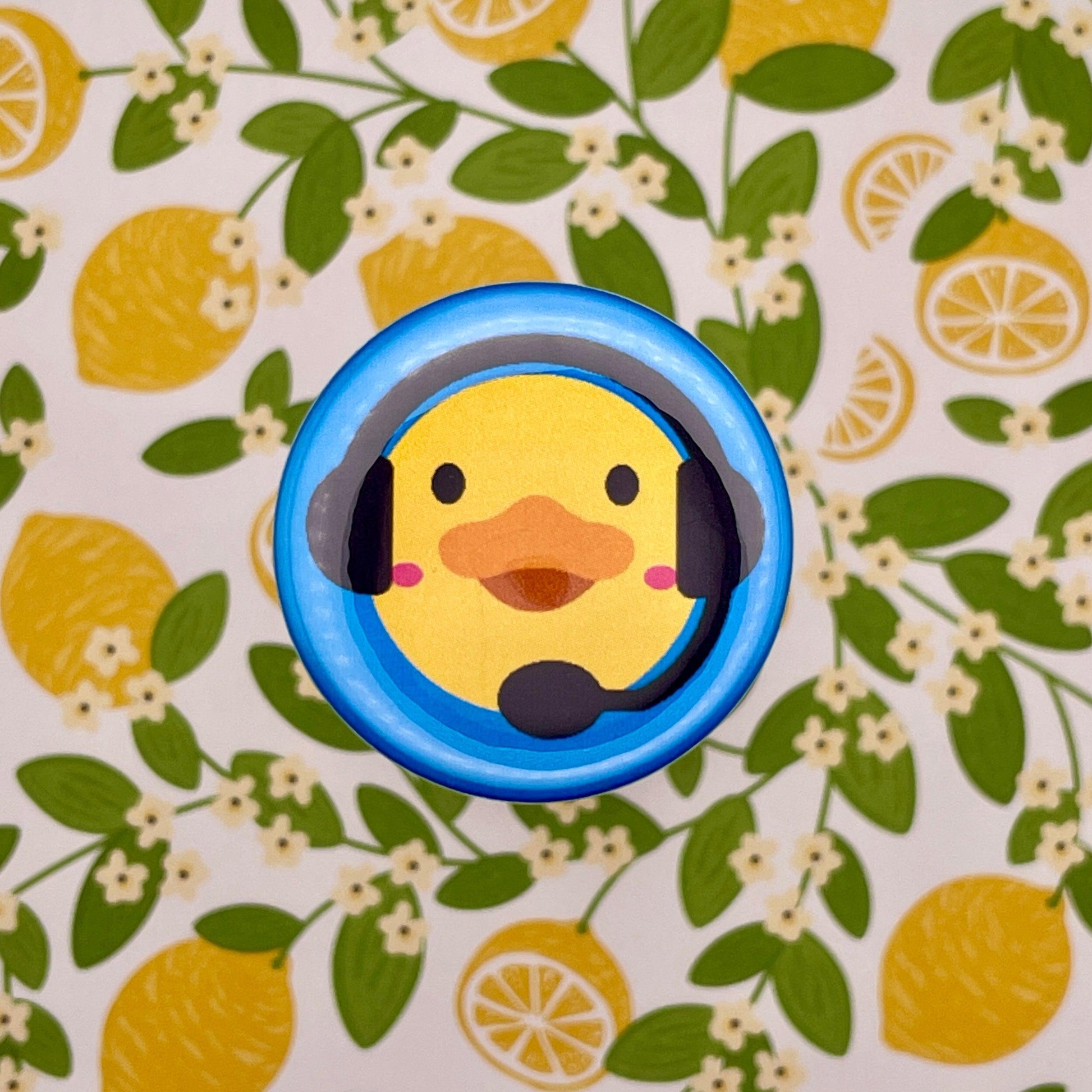 duck with stage manager headset on blue graphic on lemon background